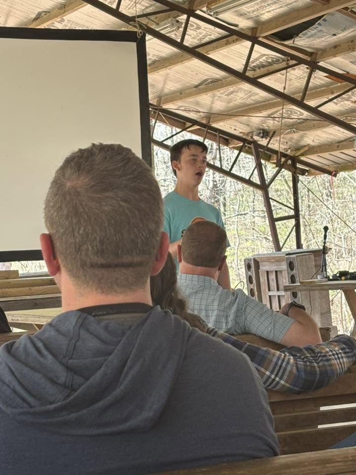 A teen leading a lesson from the pavilion podium