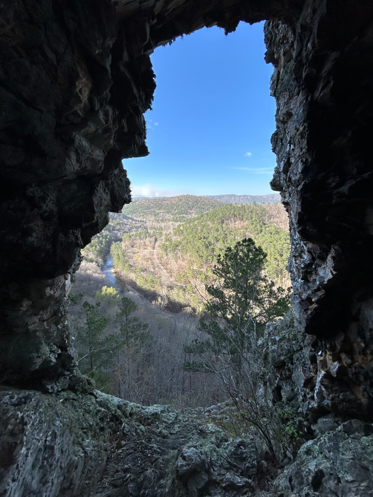 The valley framed by a stone window in the bluff rock