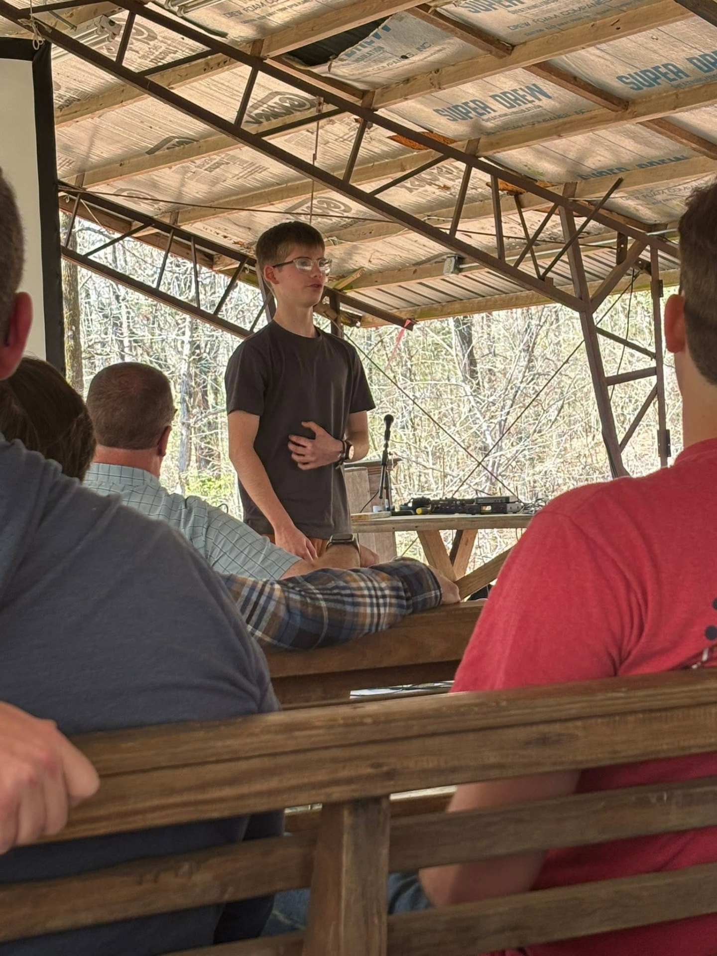 A young man speaking to the group at the retreat