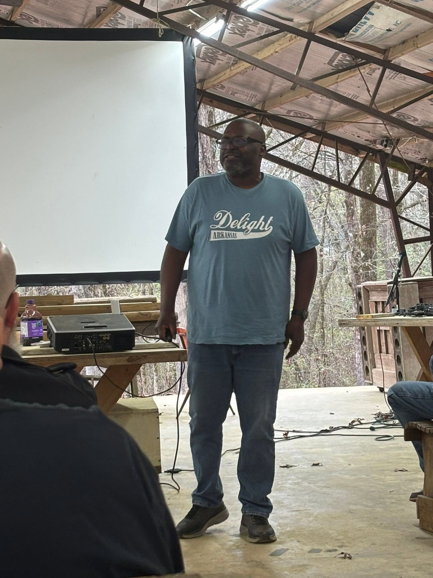 A speaker teaching under the open-air pavilion at Barton Bible Camp