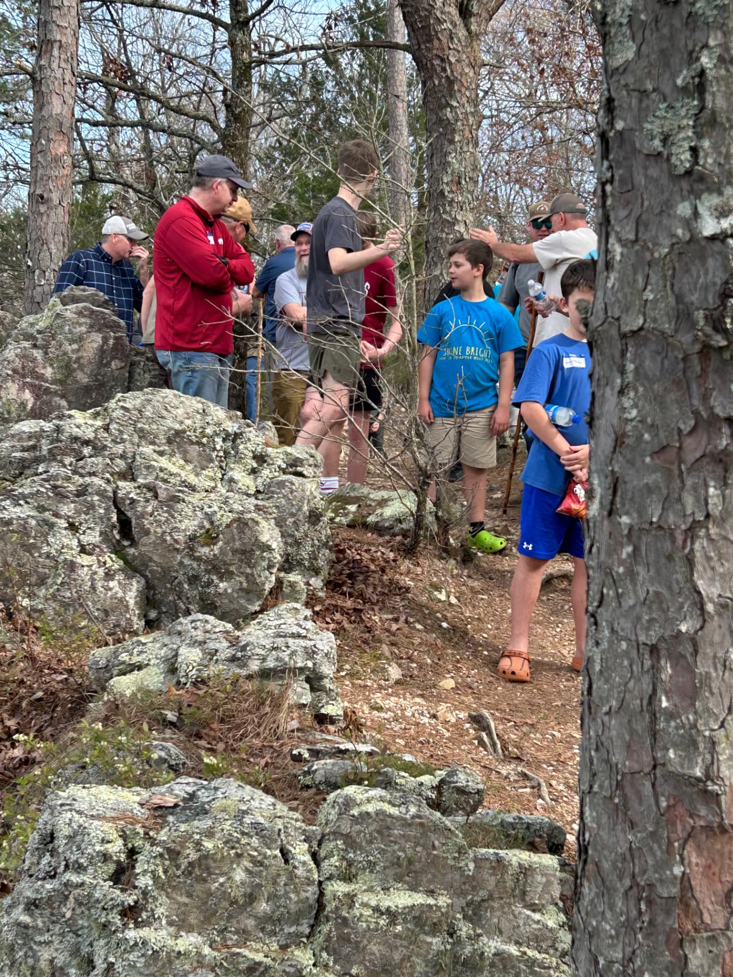 Fathers and sons resting along the rocky hiking trail
